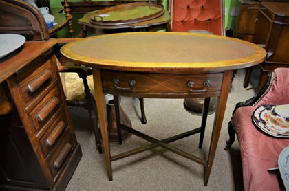 Mahogany leather top oval writing table