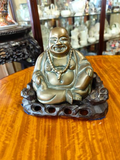 Antique chinese bronze buddha on wooden stand