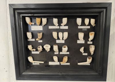 Framed collection of old pipes