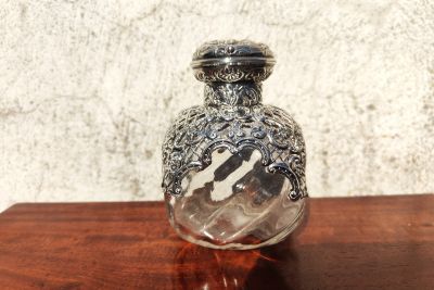 Silver topped perfume bottle