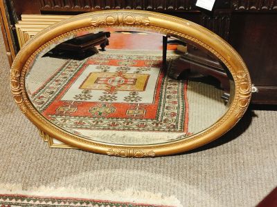 Gilt framed oval mirror