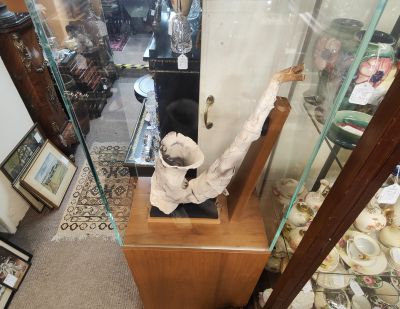 saxaphone plaster sculpture in glass display case